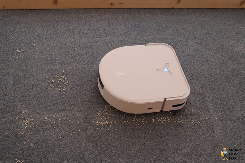 ECOVACS DEEBOT X5 OMNI saugt Linsen auf dem Teppich
